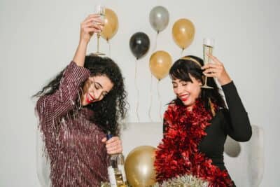 happy women with glasses of champagne making toast